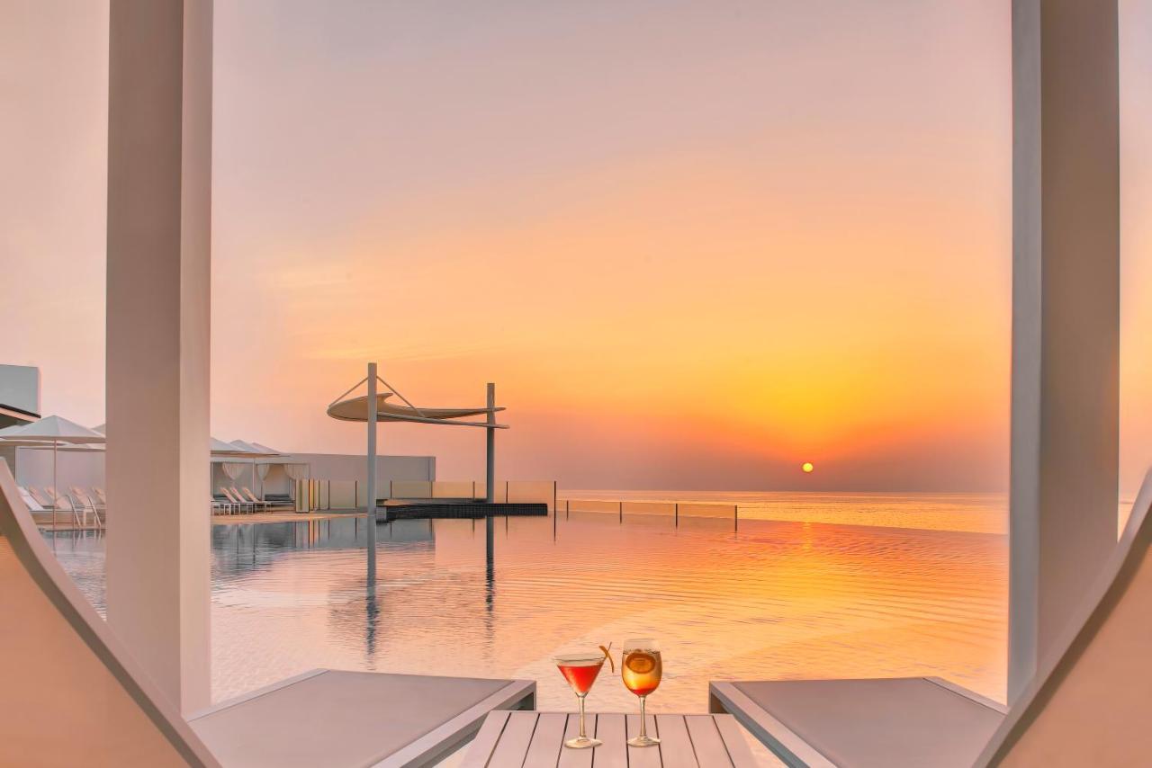 Royal M Al Aqah Beach Resort By Gewan Экстерьер фото Sunset at the pool